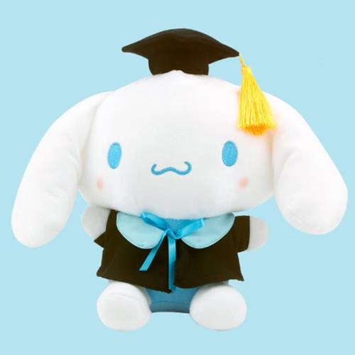 White plush toy of a character wearing a graduation cap and gown.