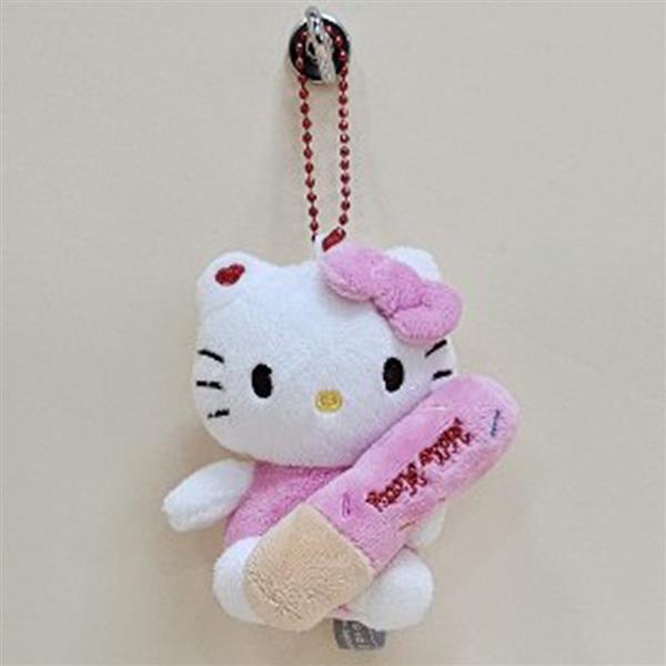 A plush Hello Kitty holding a pink baseball bat hanging on a wall.