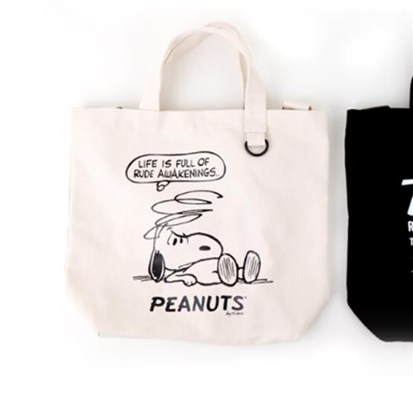 Off-white canvas tote bag with a cartoon print of Snoopy.
