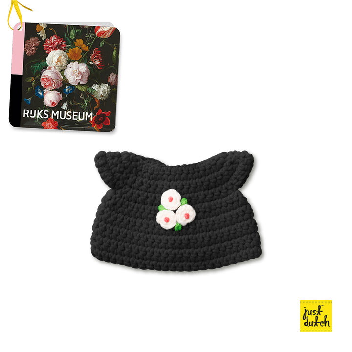 Crocheted black cat bonnet with floral applique.