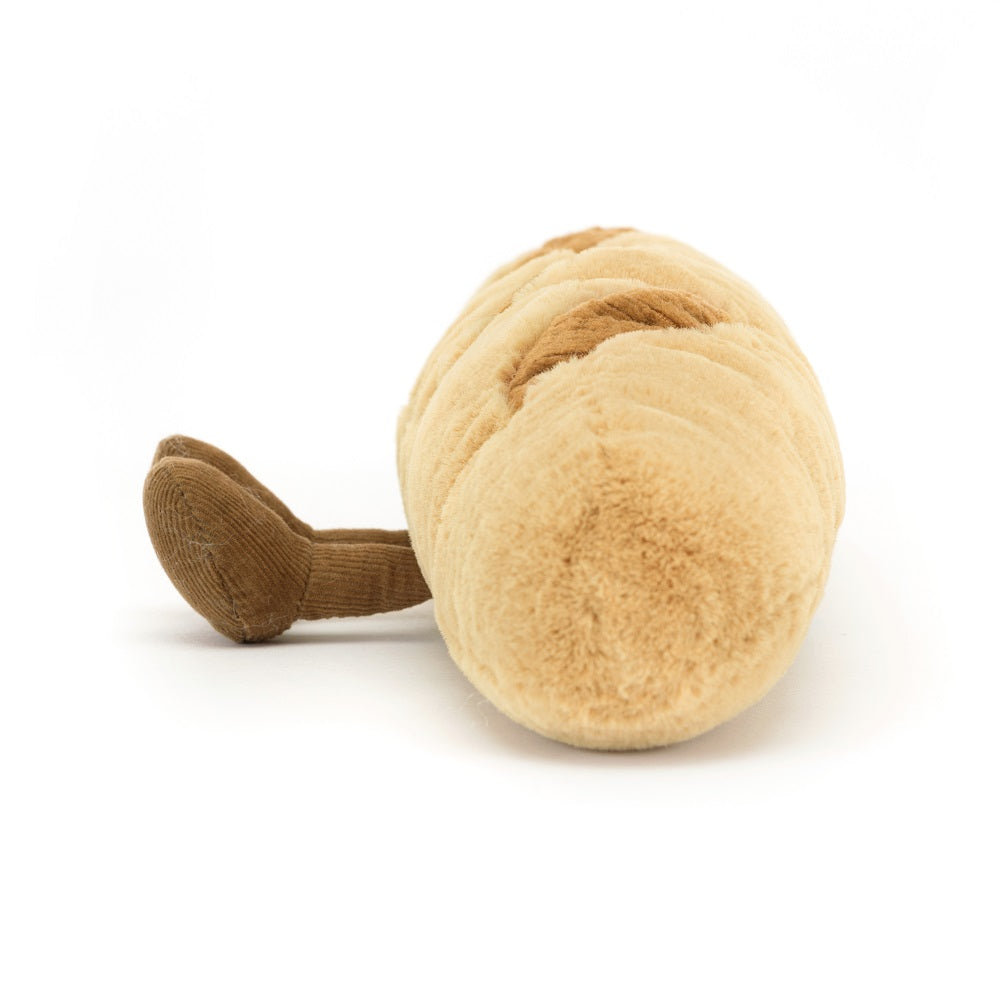 Tan plush baguette with corduroy feet on a white background.