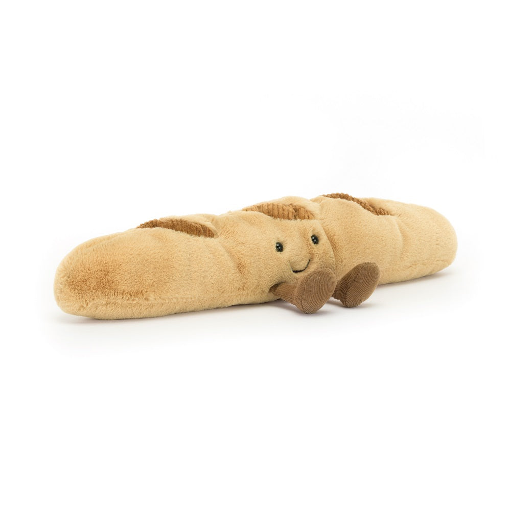 Stuffed plush baguette with a smiling face and brown corduroy feet.