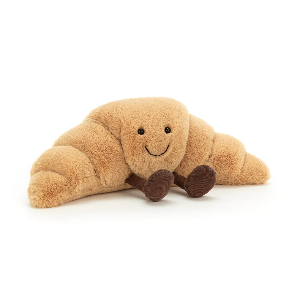 Stuffed croissant toy with smiling face.