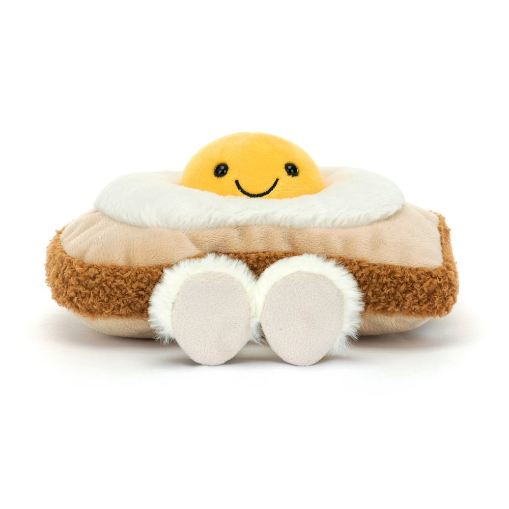 Stuffed egg plushie with smile on white background.