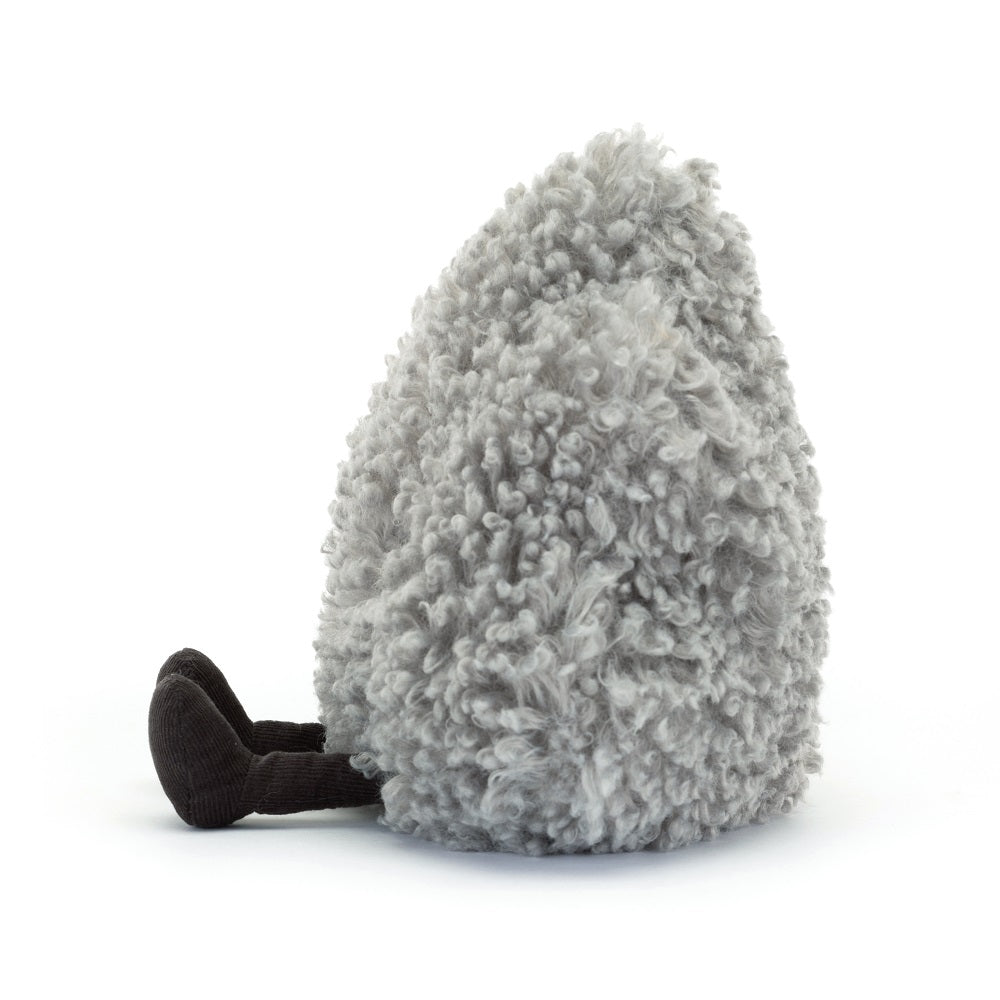 Gray, fluffy, egg-shaped stuffed animal with black corduroy legs sitting on white background.