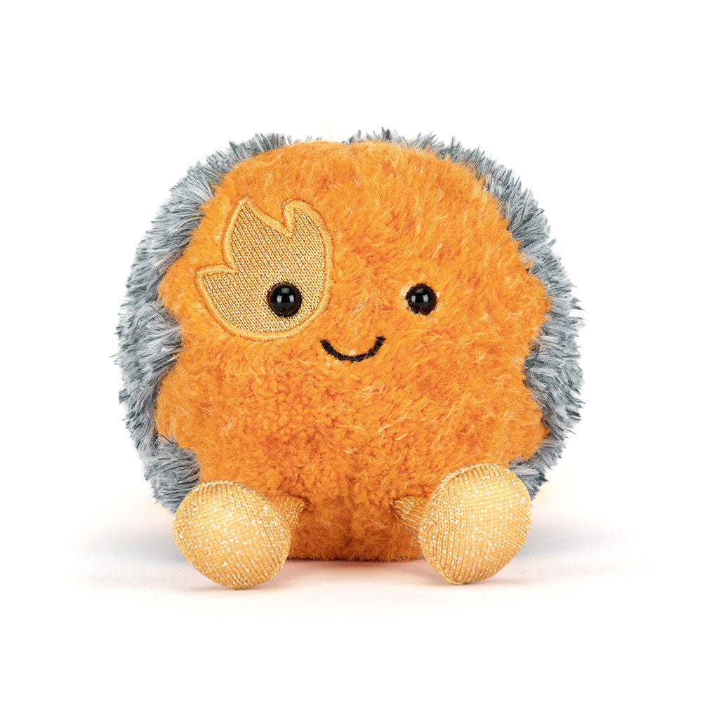 Orange plush comet toy with gray fuzzy tail and golden sparkly feet by Jellycat, featuring embroidered flame eye and smiling face, front view
