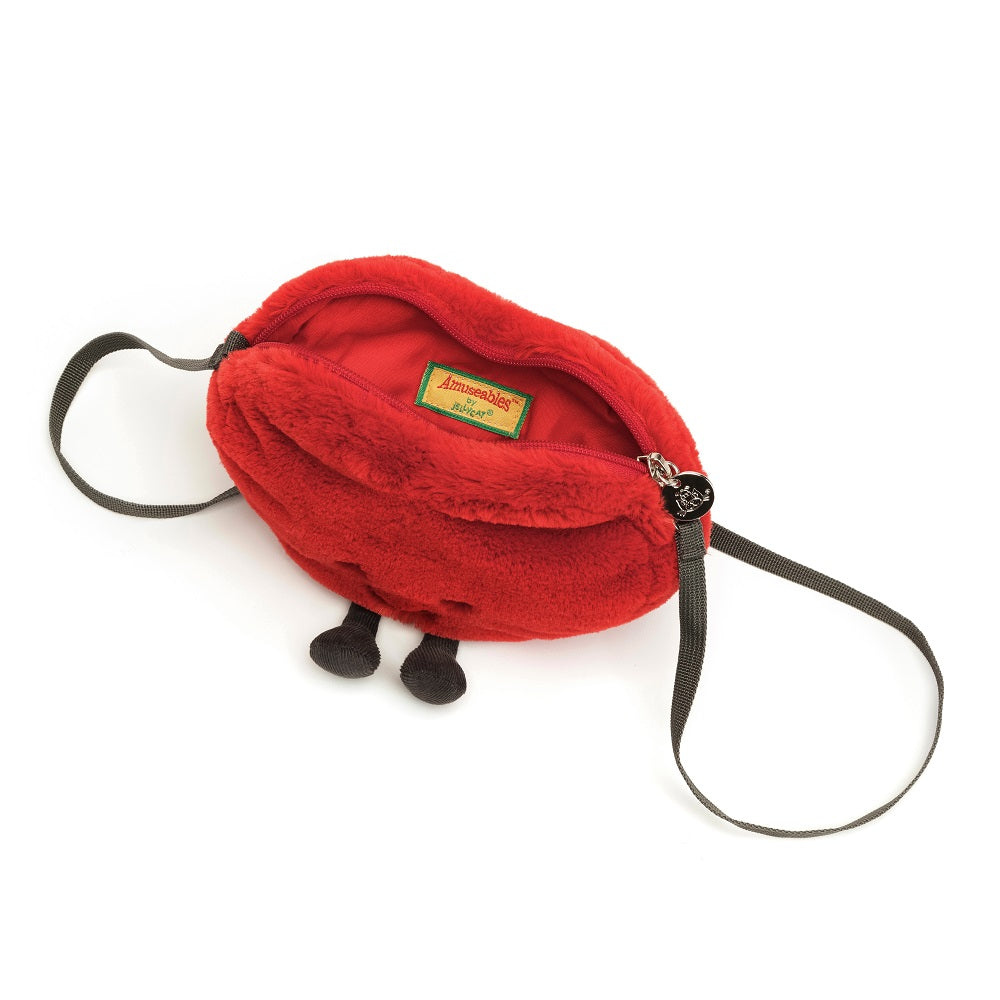 Red plush purse with shoulder straps, zipper closure, and label inside.