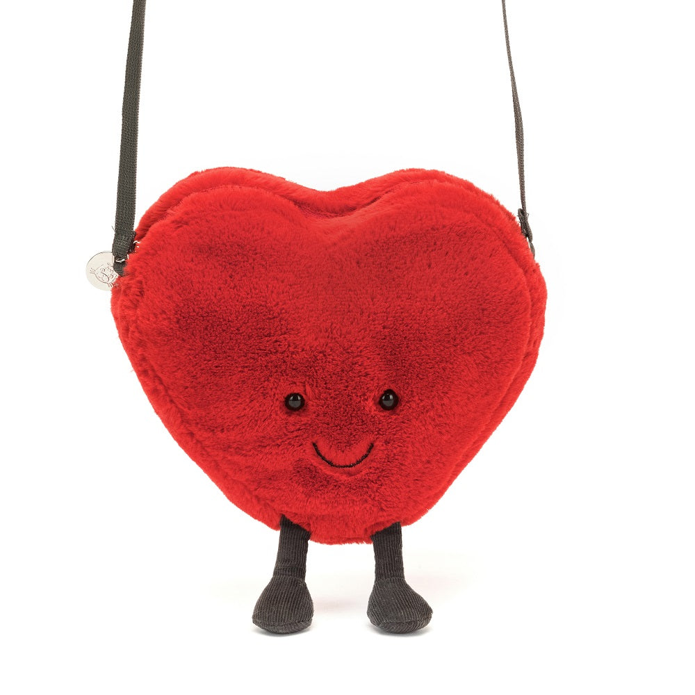 Red, fuzzy heart-shaped purse with legs and a strap.
