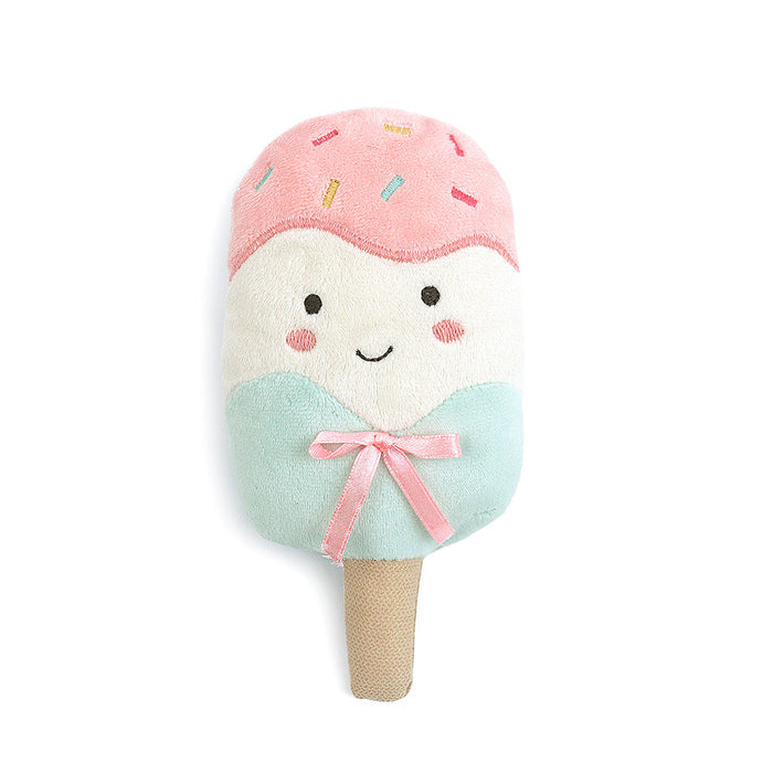 Stuffed ice cream bar toy with a pink top, white middle, mint-green bottom tied with a pink ribbon, and a brown stick.