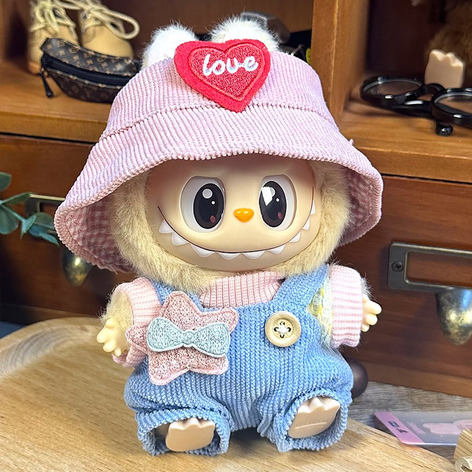 Plush doll with pink hat, blue overalls, and star patch.