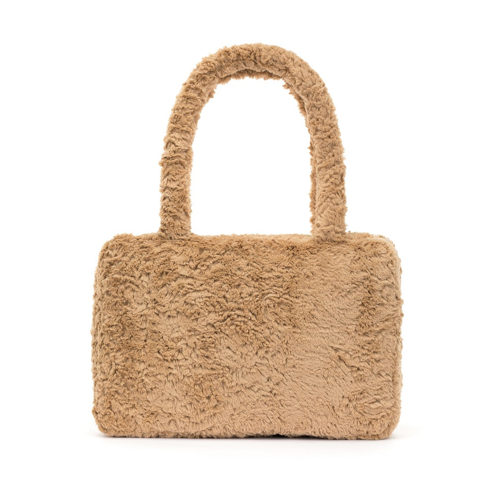Beige faux fur handbag with handles.