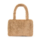 Beige faux fur handbag with handles.