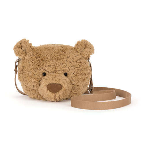 Plush tan bear-shaped shoulder bag by Jellycat with soft fur texture, black button eyes, and detachable beige strap, front view.