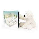 Children's board book titled "The Playful Polar Bears" with a stuffed polar bear toy.