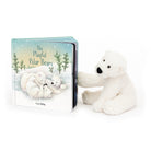 Children's book titled "The Playful Polar Bears" beside a plush polar bear toy.