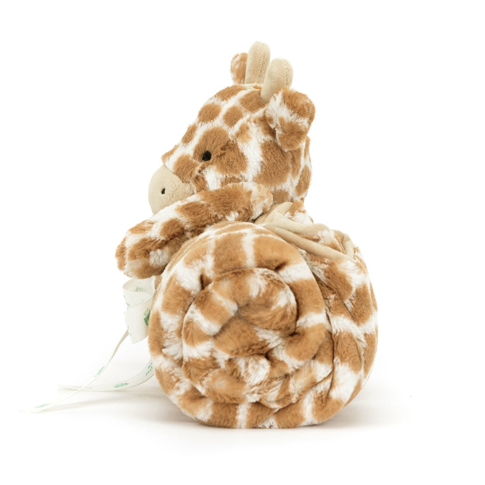 Stuffed giraffe with rolled blanket.