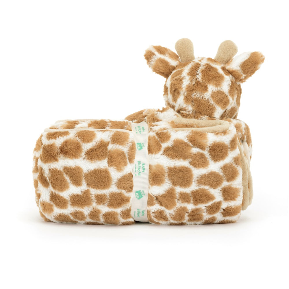Stuffed giraffe with blanket and ribbon.