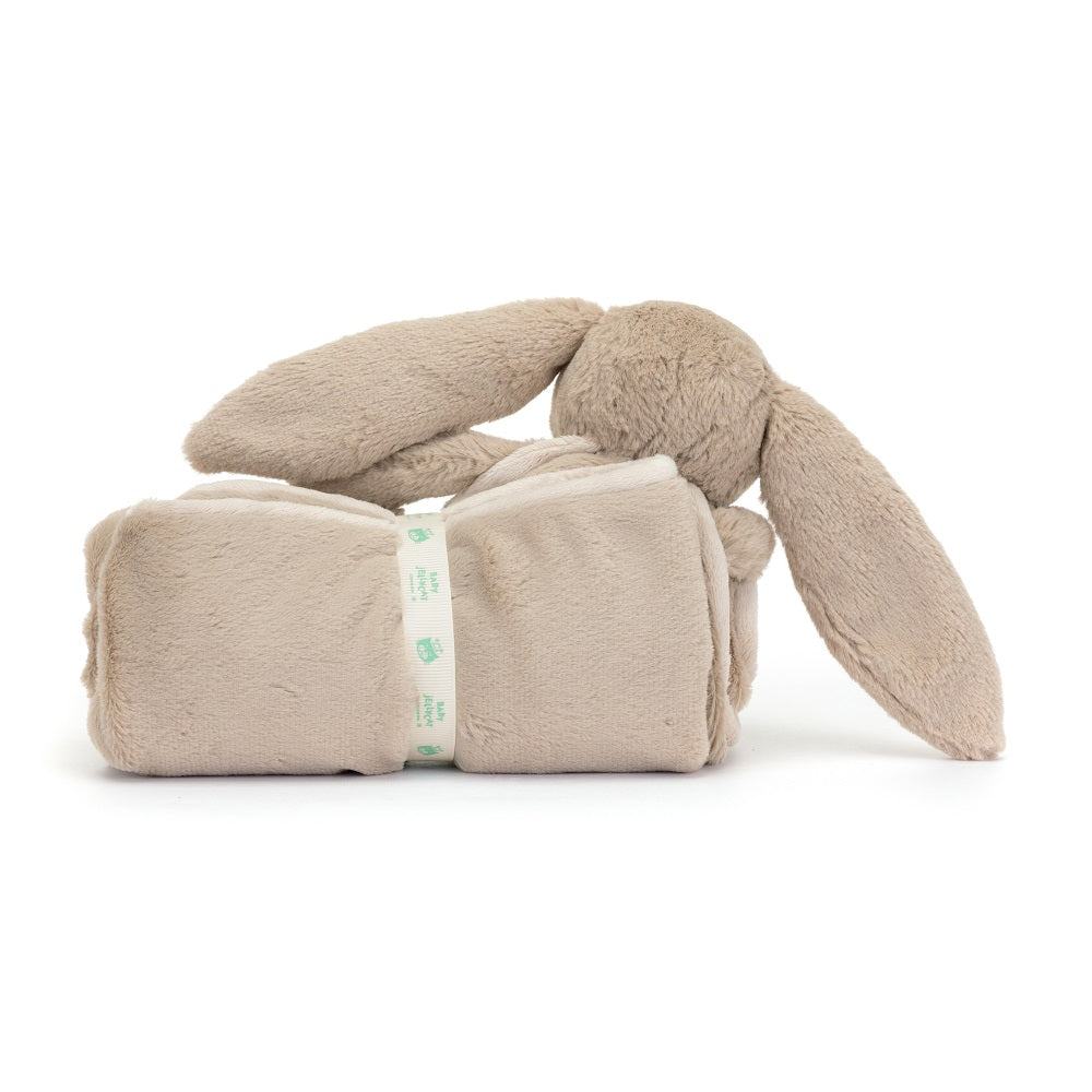 Beige bunny plush toy with rolled blanket.