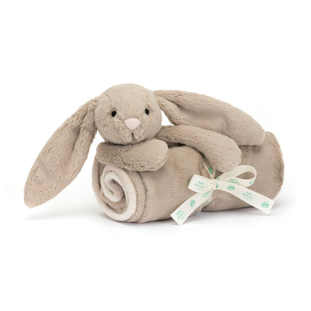 Tan bunny plush toy in a blanket roll, tied with a ribbon.