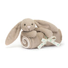 Tan bunny plush toy in a blanket roll, tied with a ribbon.