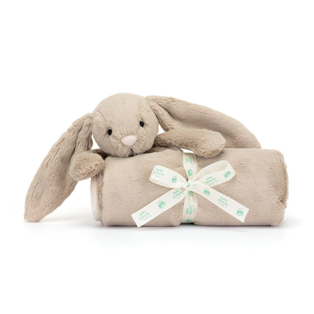 Tan bunny plush toy with a rolled tan blanket tied with a white "Baby Jellycat" ribbon.