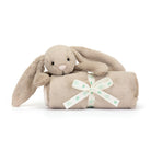 Tan bunny plush toy with a rolled tan blanket tied with a white "Baby Jellycat" ribbon.