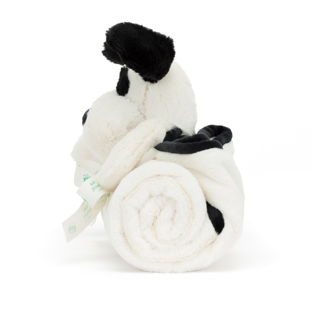 Stuffed panda and rolled up white and black blanket with ribbon.
