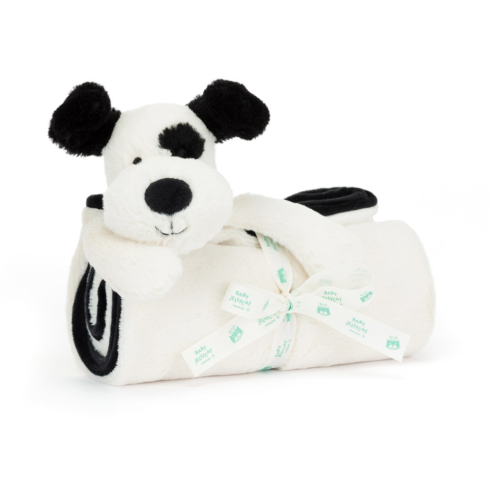 Stuffed dog with blanket and ribbon.