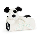 Stuffed dog with blanket and ribbon.