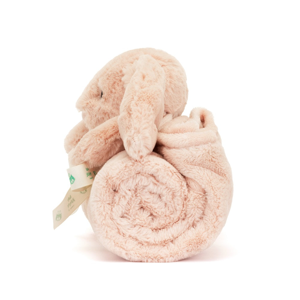 Tan plush bunny with rolled blanket.