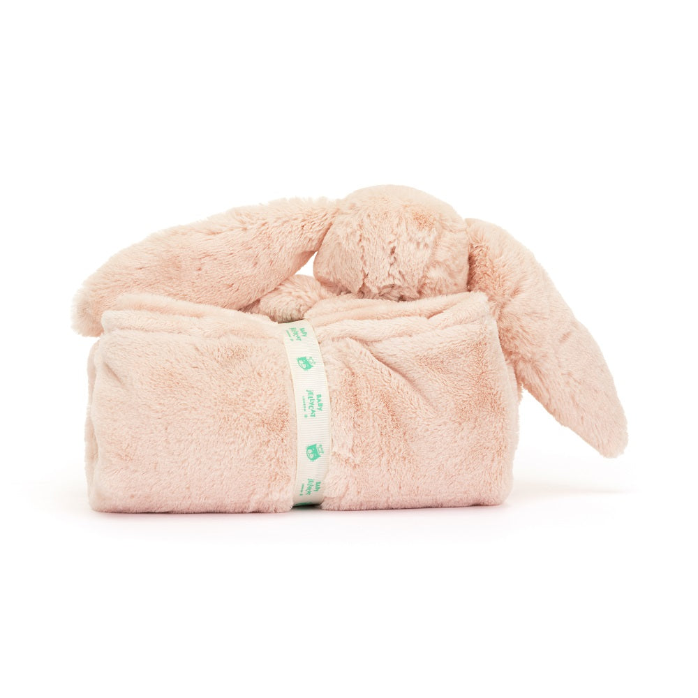 Pink bunny plush toy wrapped in a blanket with a ribbon.