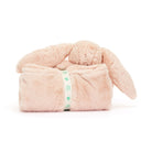 Pink bunny plush toy wrapped in a blanket with a ribbon.