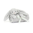 Gray bunny stuffed animal wrapped in a gray blanket with a white ribbon.