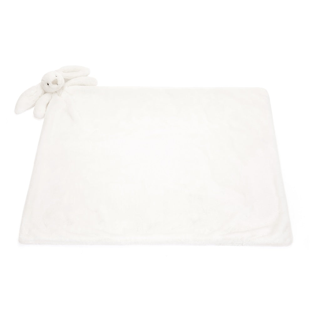 White plush blanket with a bunny toy.