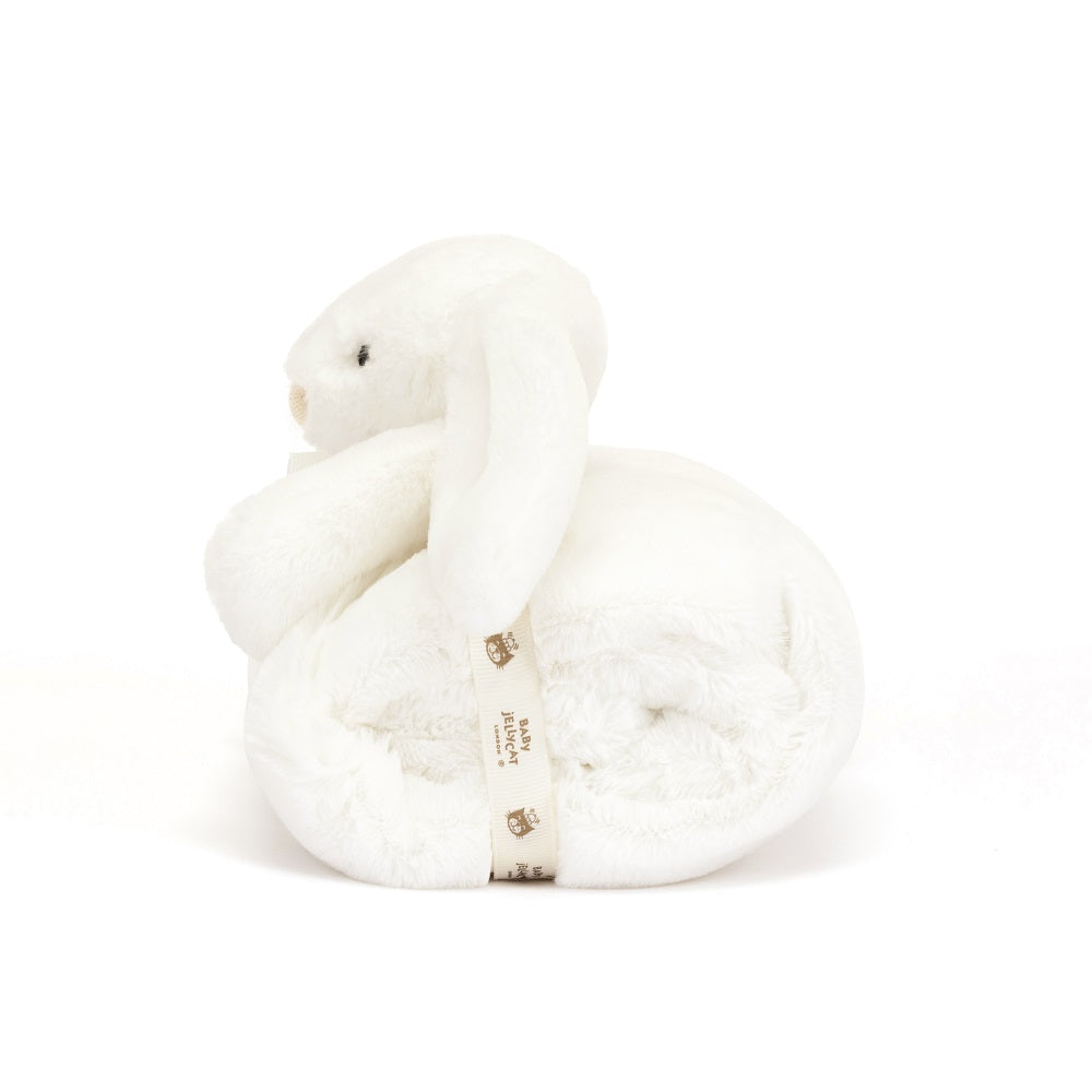 White plush bunny comforter rolled and tied with branded ribbon.