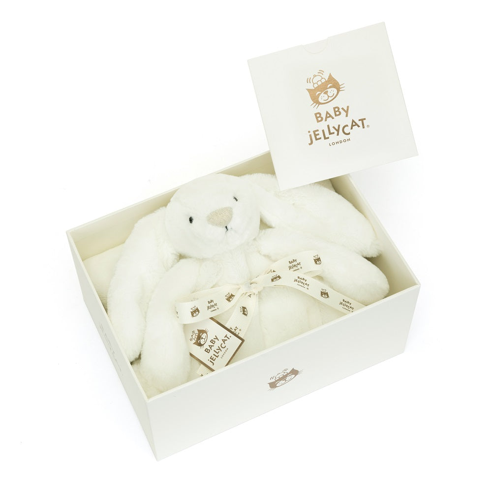White bunny plush toy in a gift box with ribbon.