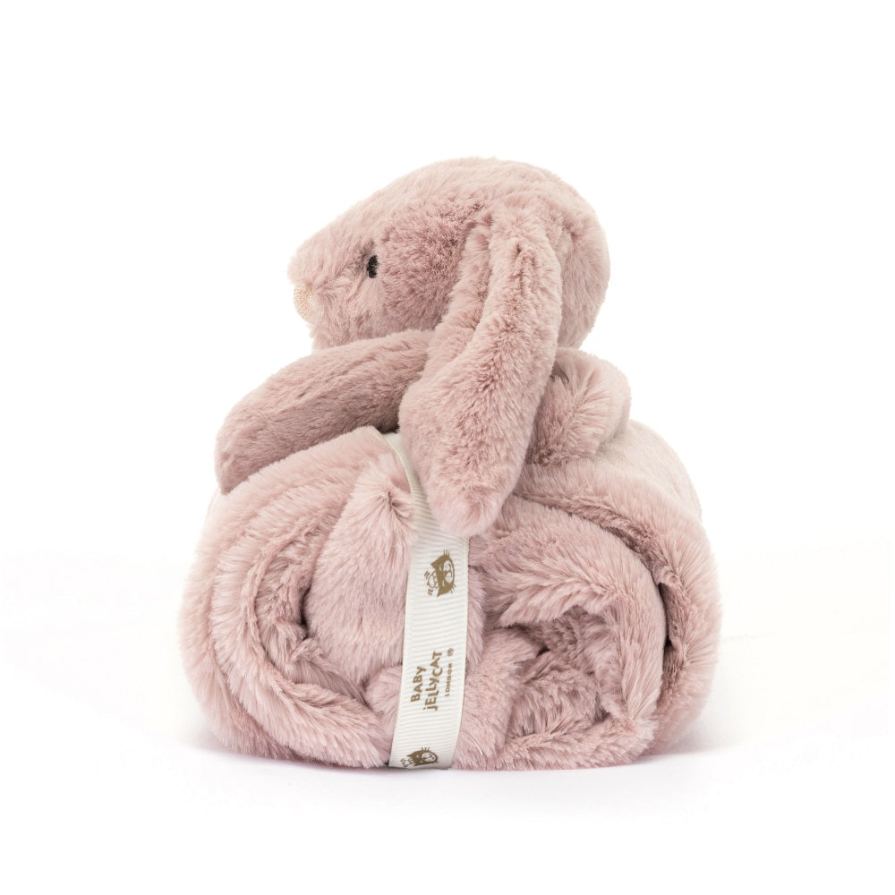A pink plush bunny wrapped in a blanket with a ribbon.