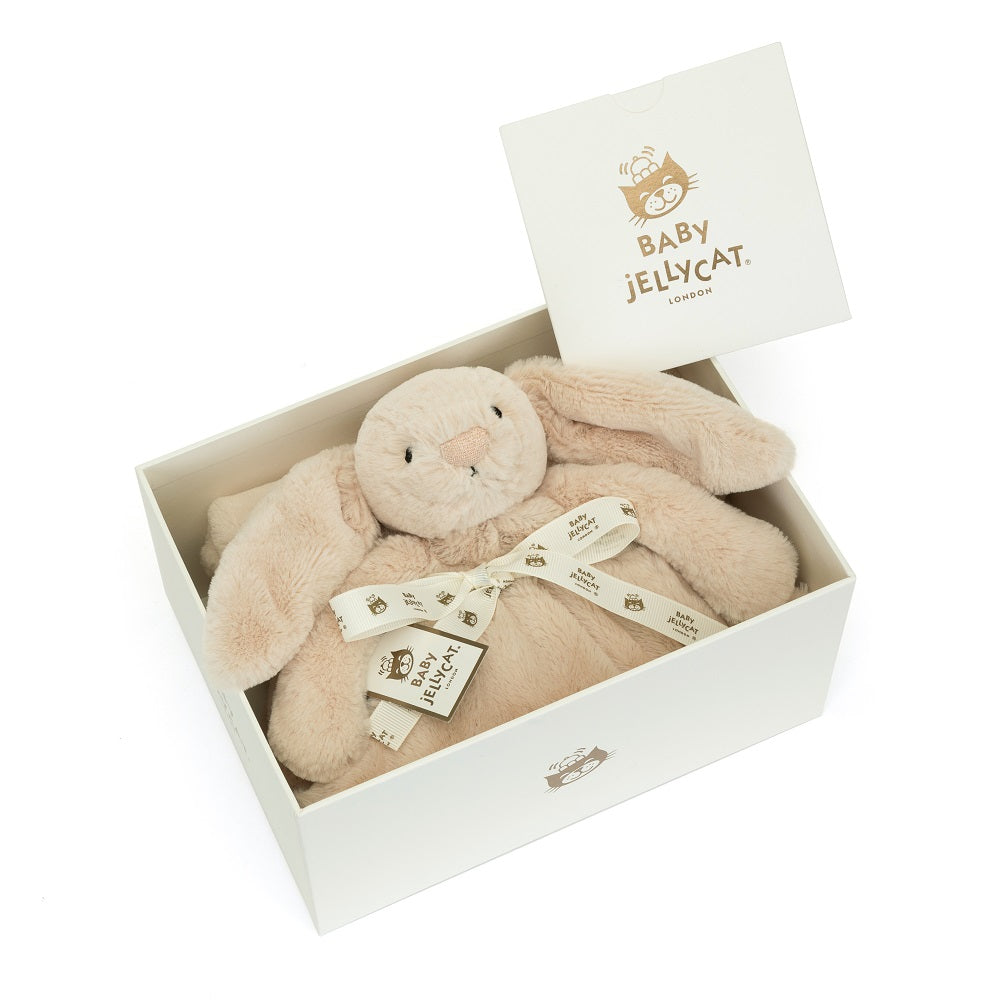 A tan stuffed bunny in a white gift box with a white ribbon.