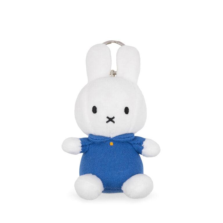 White plush Miffy rabbit in a blue knit romper.