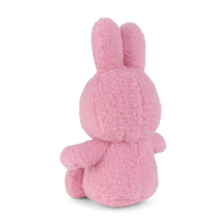 Pink plush bunny toy, rear view.