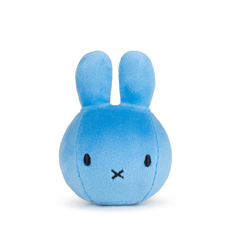 Blue plush rabbit toy with black eyes and mouth.