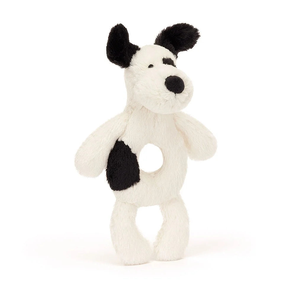 White and black stuffed dog toy with a hole in its stomach.