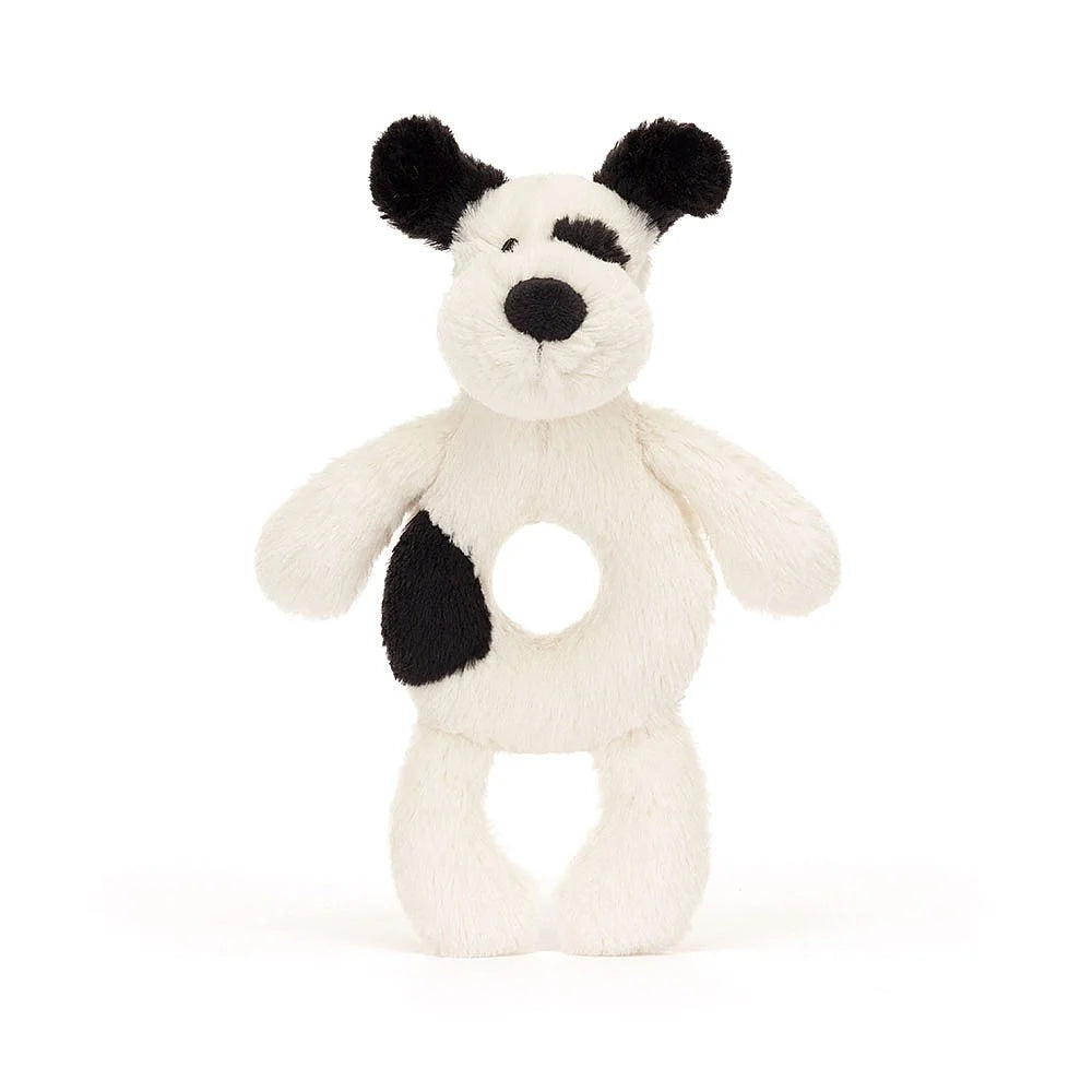 Stuffed dog toy with white fur, black spots, and a hole in the torso.
