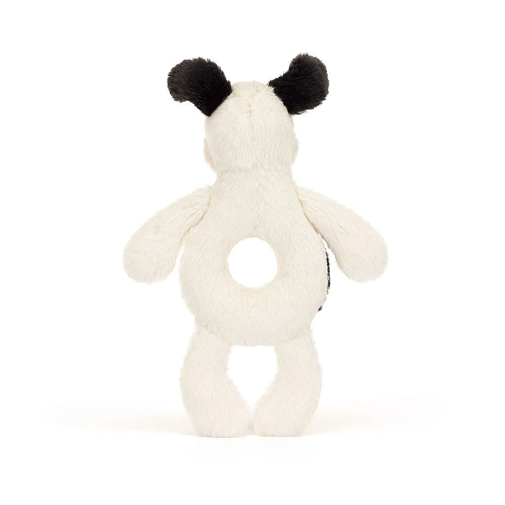 Rear view of a white and black stuffed toy with a hole in its midsection.