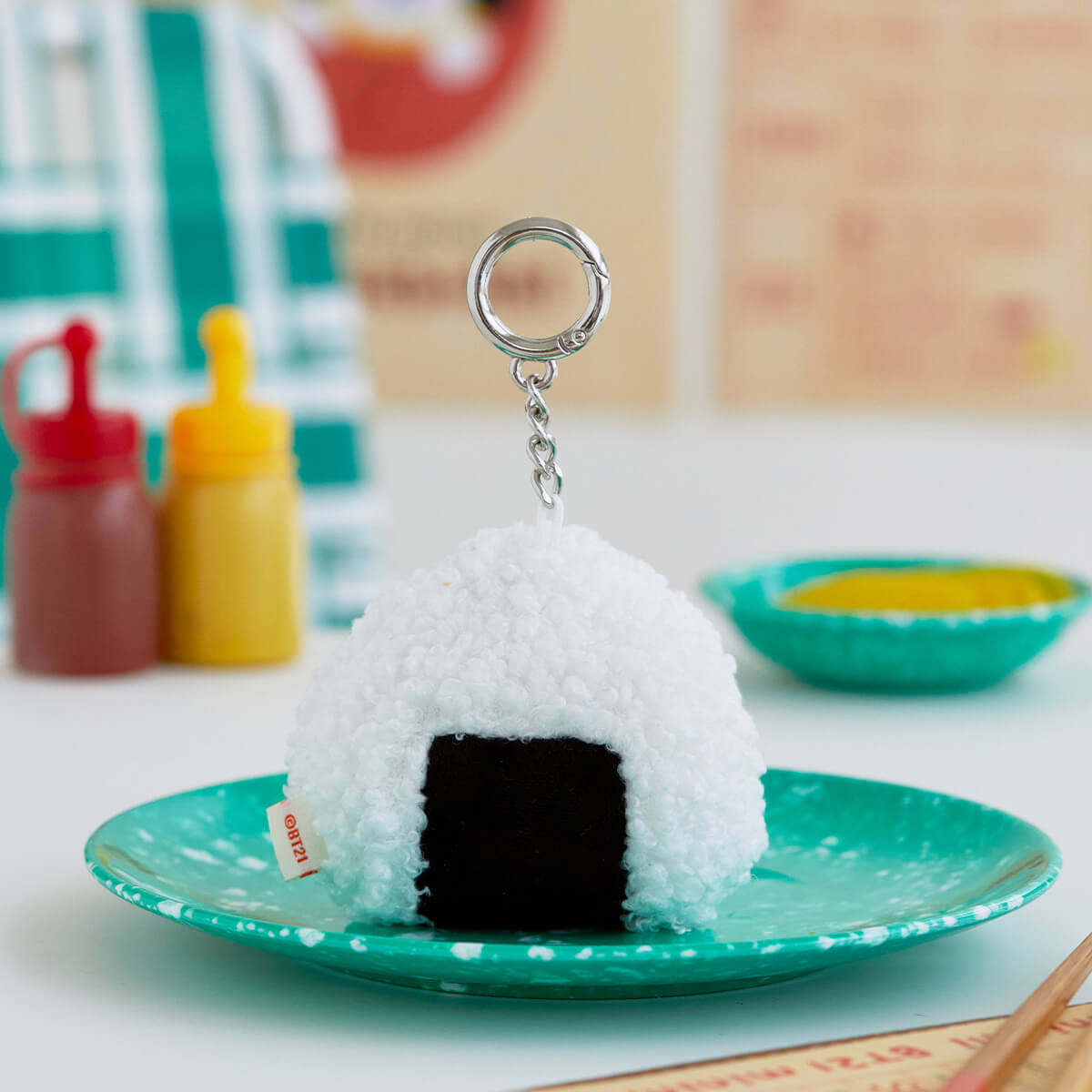 Onigiri keychain, white rice, black nori, green plate, silver ring.