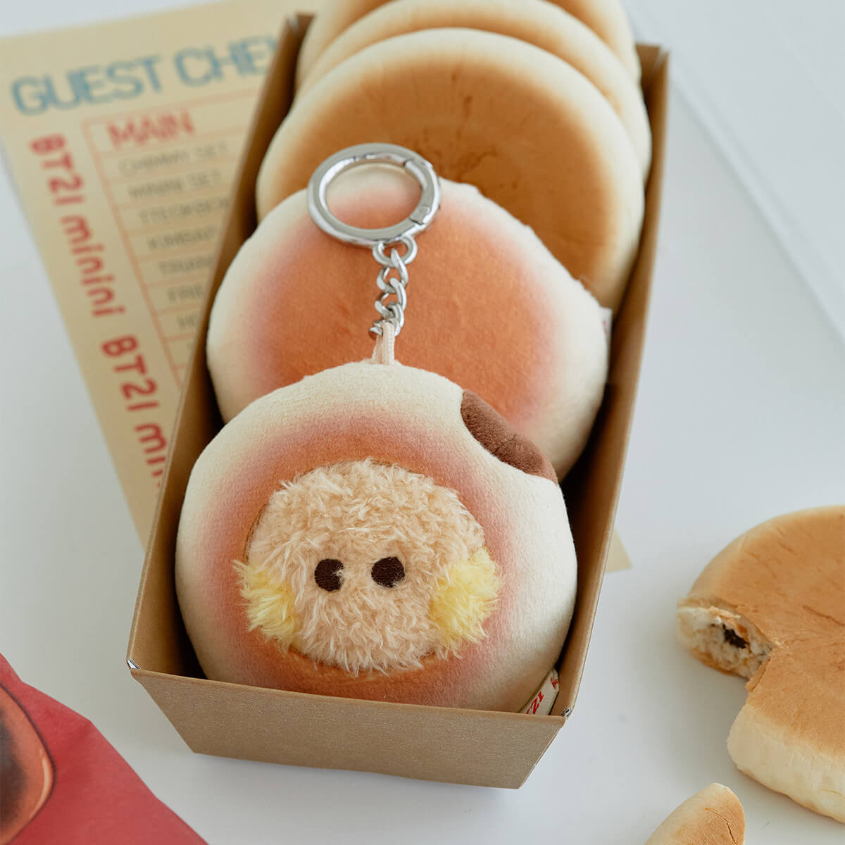 A box of plush buns, one with a dog face keychain.