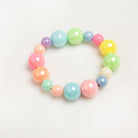 A colorful bead bracelet with pastel shades of pink, blue, green, yellow, and orange on a white surface.