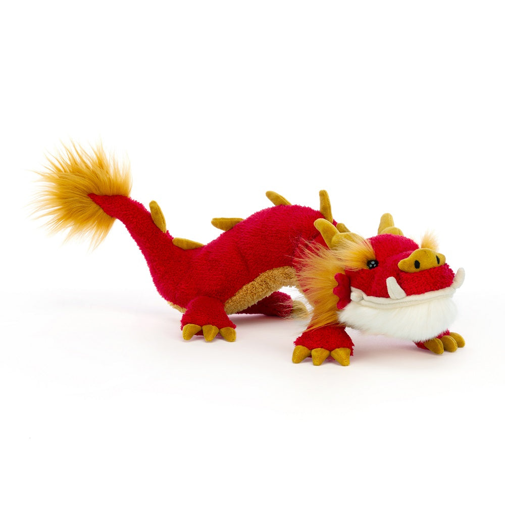 Red and tan stuffed dragon with yellow spikes.