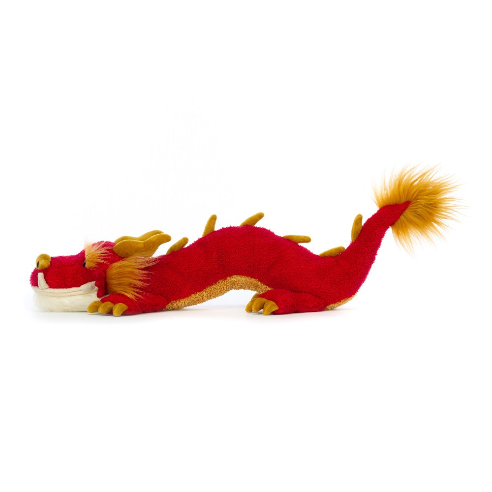 Red and gold stuffed dragon toy.