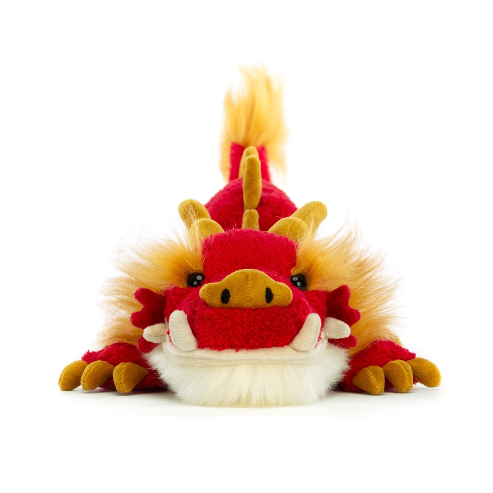 Red and yellow stuffed dragon toy.